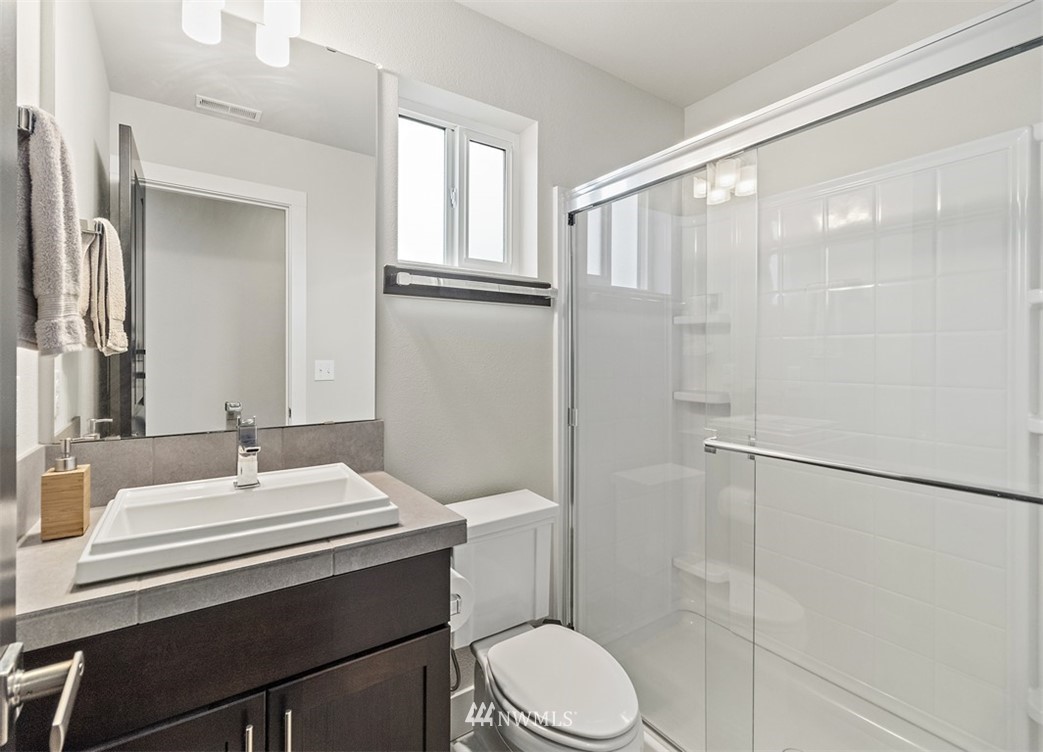 20515 3rd Avenue Southeast, Unit 14 Bothell, WA 98012 - Photo 3 of 20 a bathroom with a sink toilet and shower