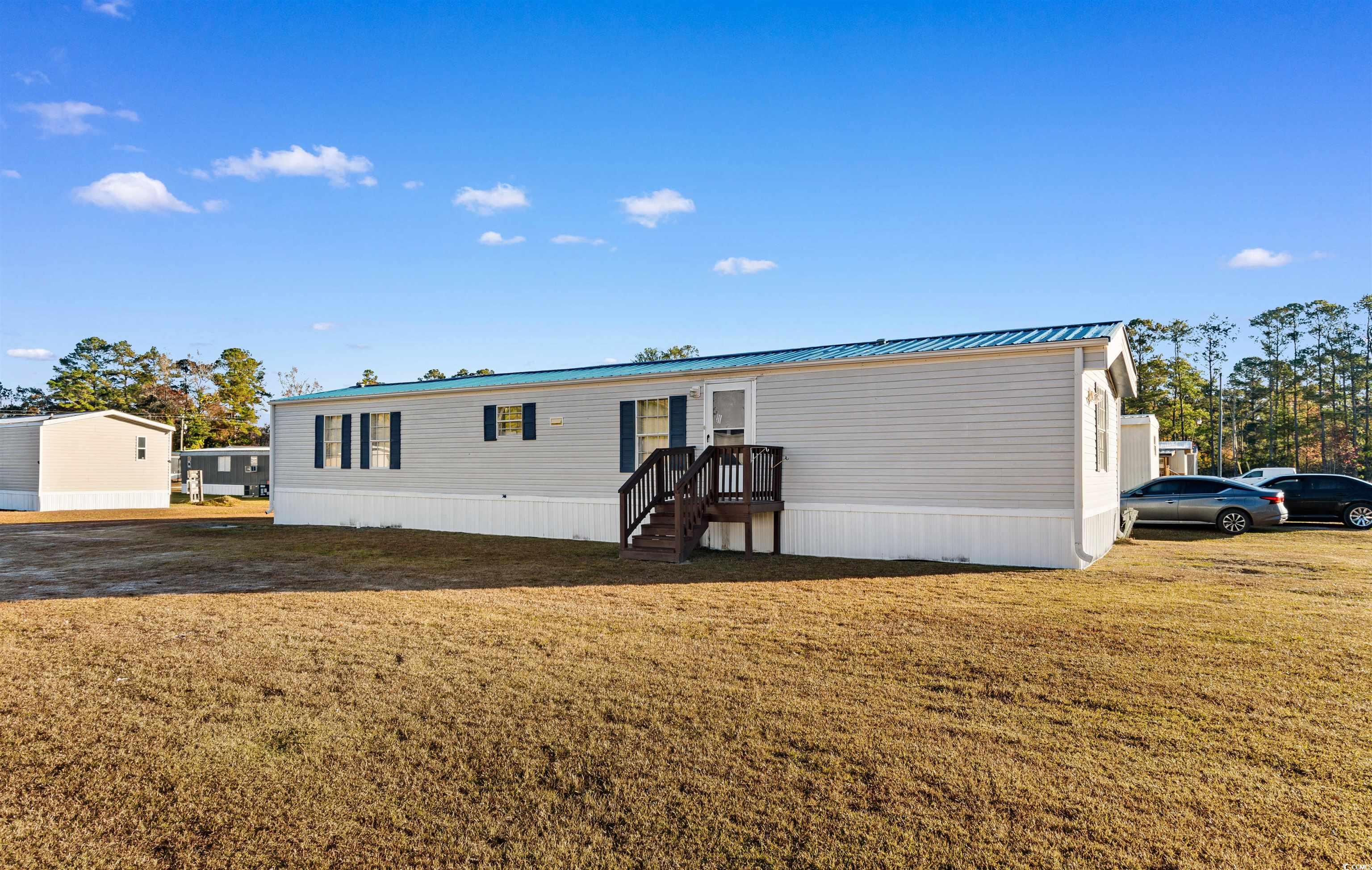 2273 Python Circle Conway, SC 29526 - Photo 2 of 38 View of front facade featuring a metal roof and a front lawn