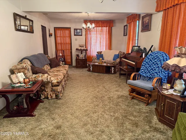 a living room with furniture a large window and bookshelf