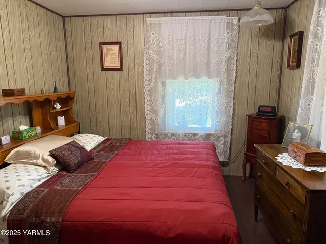 a bedroom with a bed and a table