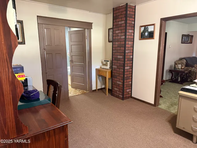 a bathroom with a granite countertop sink mirror vanity and toilet