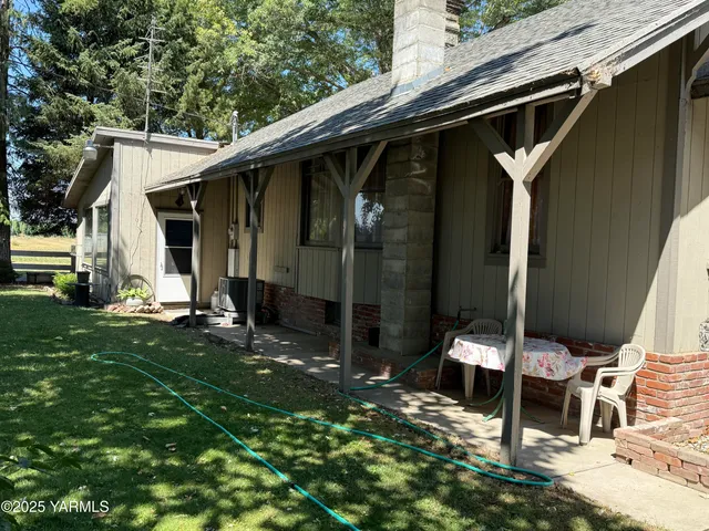 a view of backyard with a patio