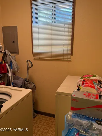 a bathroom with a granite countertop toilet and a sink