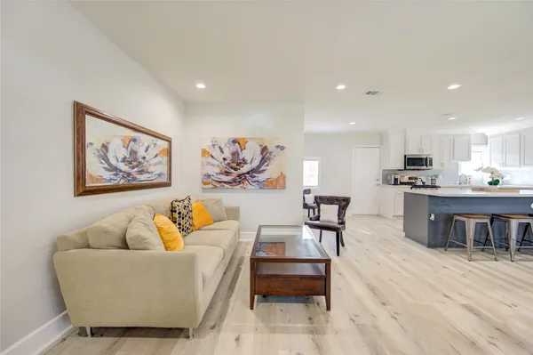 a living room with furniture and kitchen view