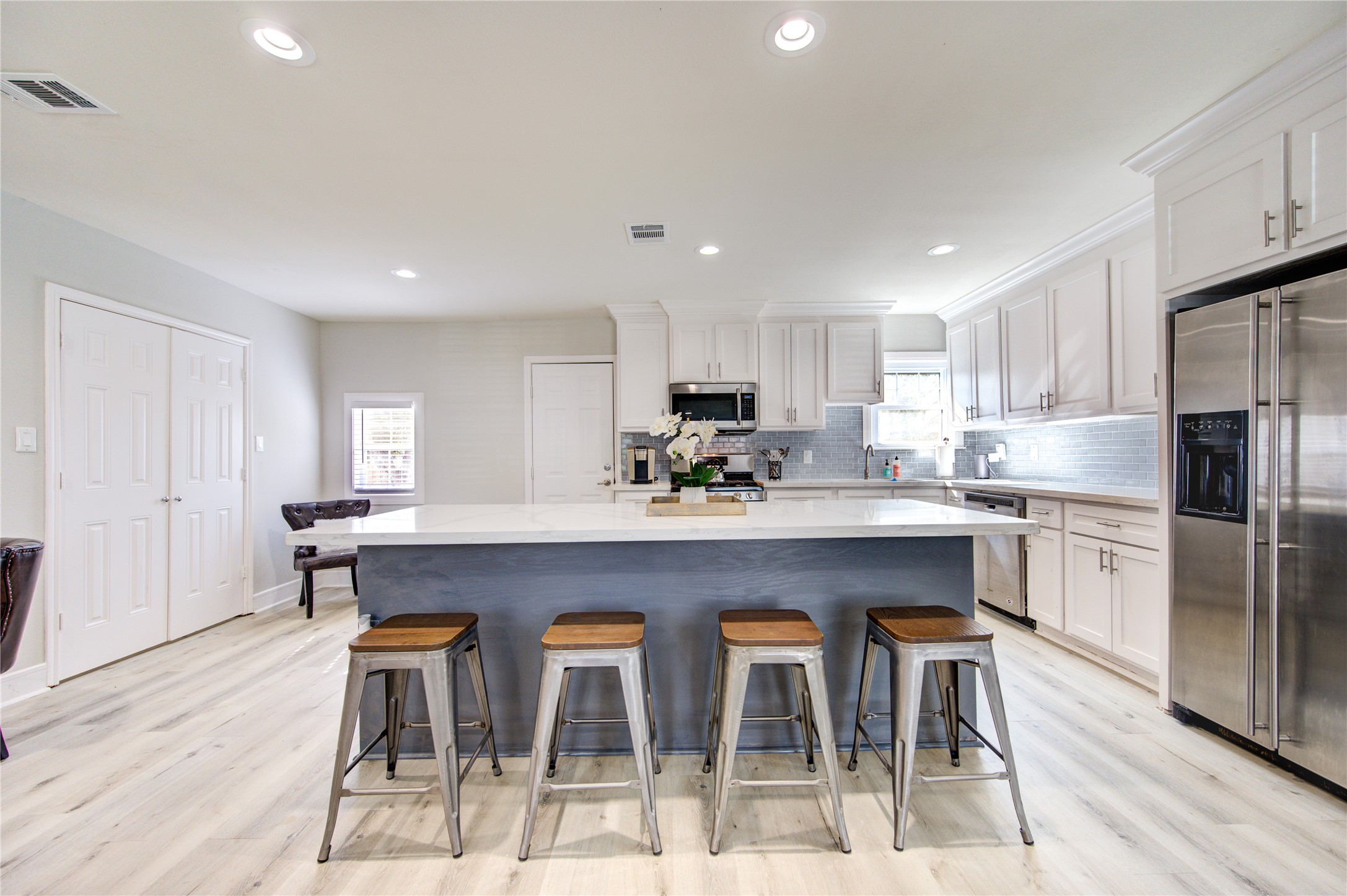 4522 Dixie Drive Houston, TX 77021 - Photo 11 of 33 a kitchen with stainless steel appliances granite countertop a sink a stove a dining table and chairs