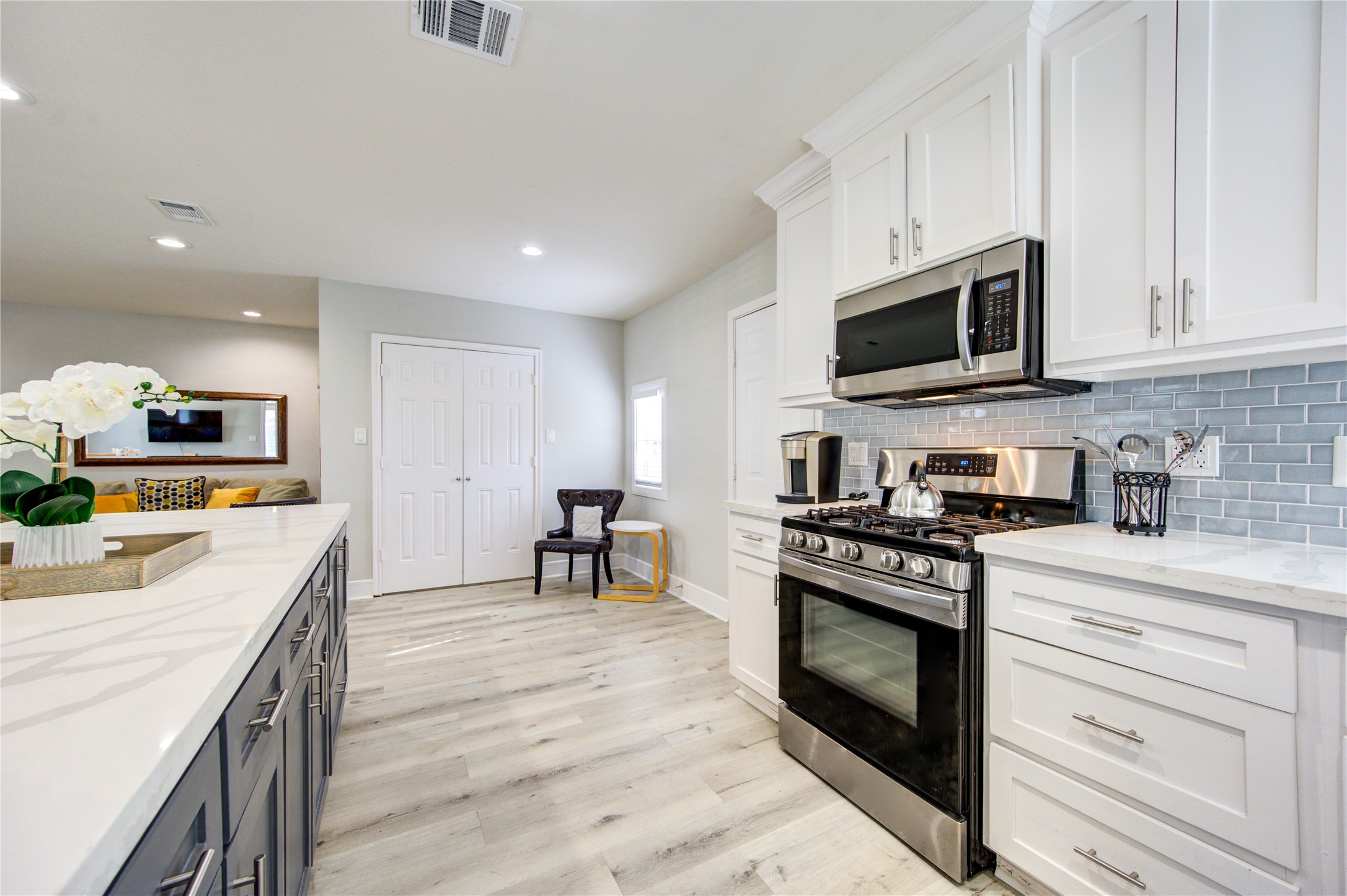 4522 Dixie Drive Houston, TX 77021 - Photo 8 of 33 a kitchen with stainless steel appliances granite countertop a stove top oven a sink dishwasher and white cabinets with wooden floor