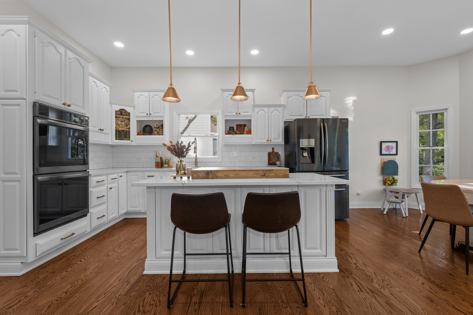 408 Delaware Circle Bolingbrook, IL 60440 - Photo 11 of 47 a kitchen with stainless steel appliances granite countertop a stove a sink a microwave a refrigerator and white cabinets with wooden floor