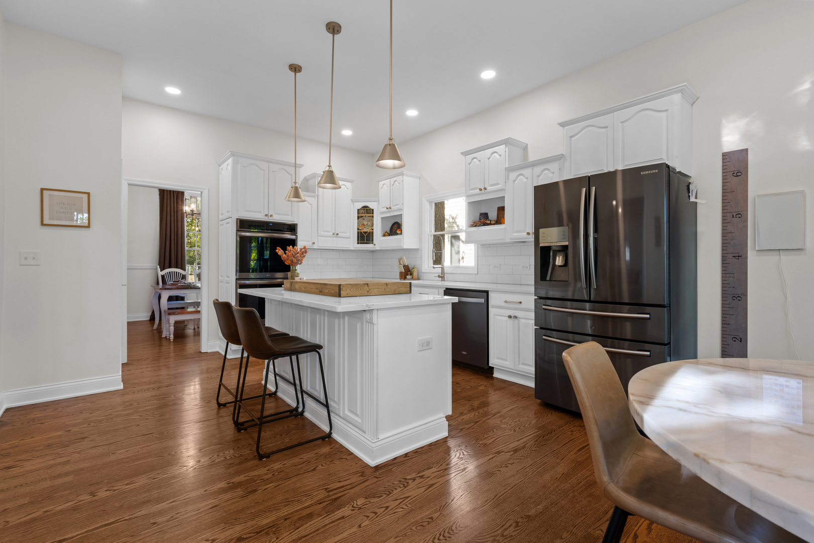 408 Delaware Circle Bolingbrook, IL 60440 - Photo 13 of 47 a kitchen with kitchen island white cabinets and stainless steel appliances
