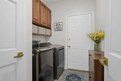 a kitchen with stainless steel appliances granite countertop cabinets and a potted plant
