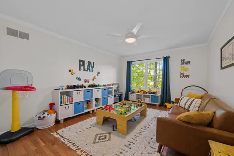 a living room with furniture toys and a window