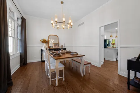 a view of a dining room with furniture wooden floor and chandelier