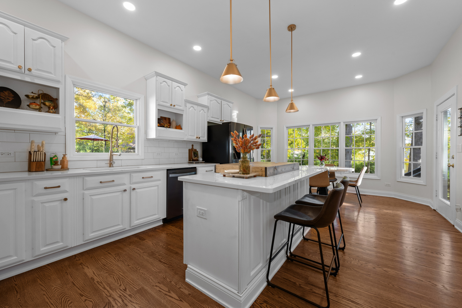 408 Delaware Circle Bolingbrook, IL 60440 - Photo 10 of 47 a kitchen with stainless steel appliances granite countertop wooden floor sink stove dining table and chairs