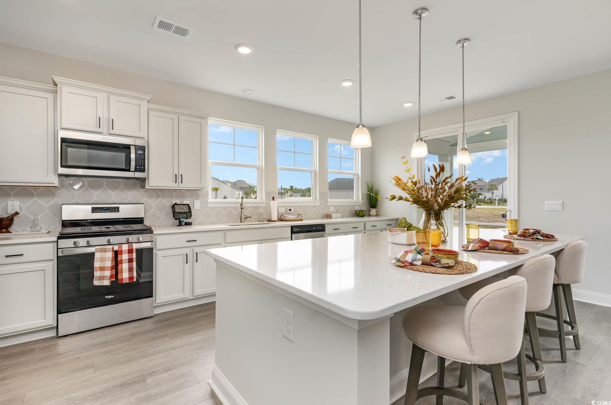 748 Doonbeg Court Conway, SC 29526 - Photo 6 of 30 Kitchen with tasteful backsplash, stainless steel appliances, plenty of natural light, a center island, and recessed lighting