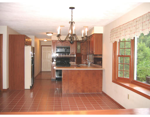 39 Paige Farm Road Amesbury, MA 01913 - Photo 7 of 9 a living room with kitchen island granite countertop furniture and a chandelier