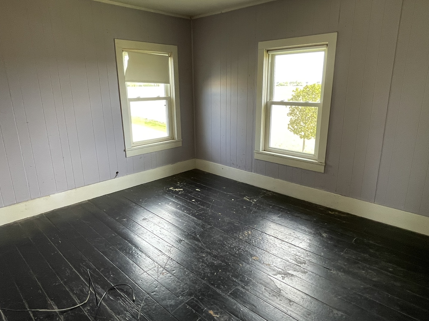 6808 South Oak Grove Road Harvard, IL 60033 - Photo 11 of 18 an empty room with wooden floor and windows