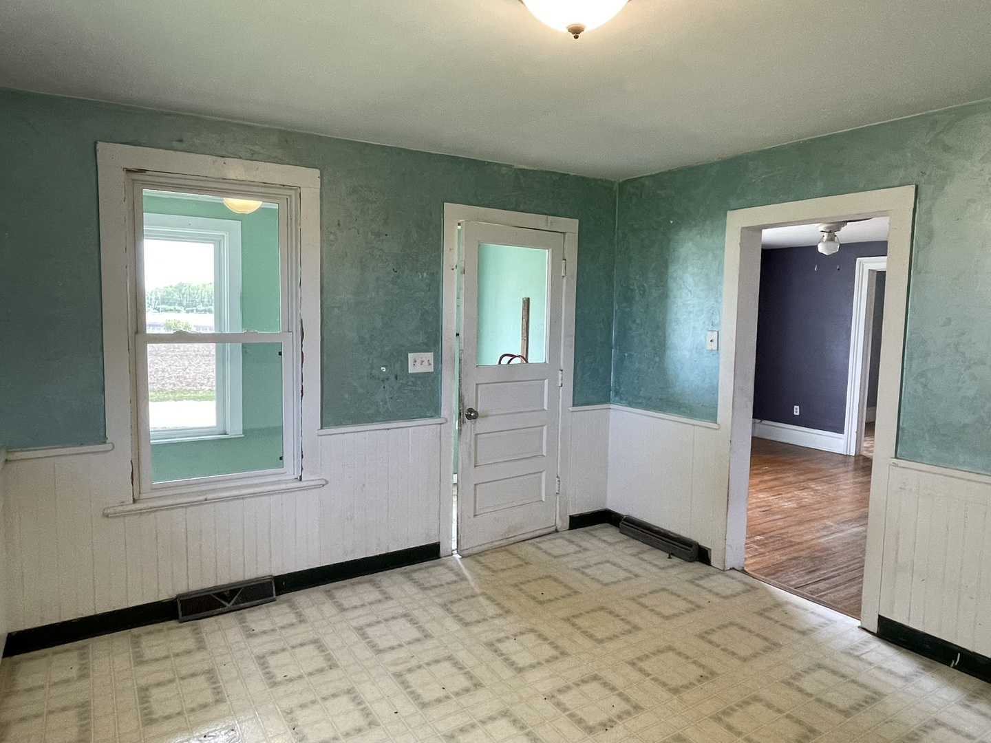 6808 South Oak Grove Road Harvard, IL 60033 - Photo 3 of 18 en empty room with window and wooden floor