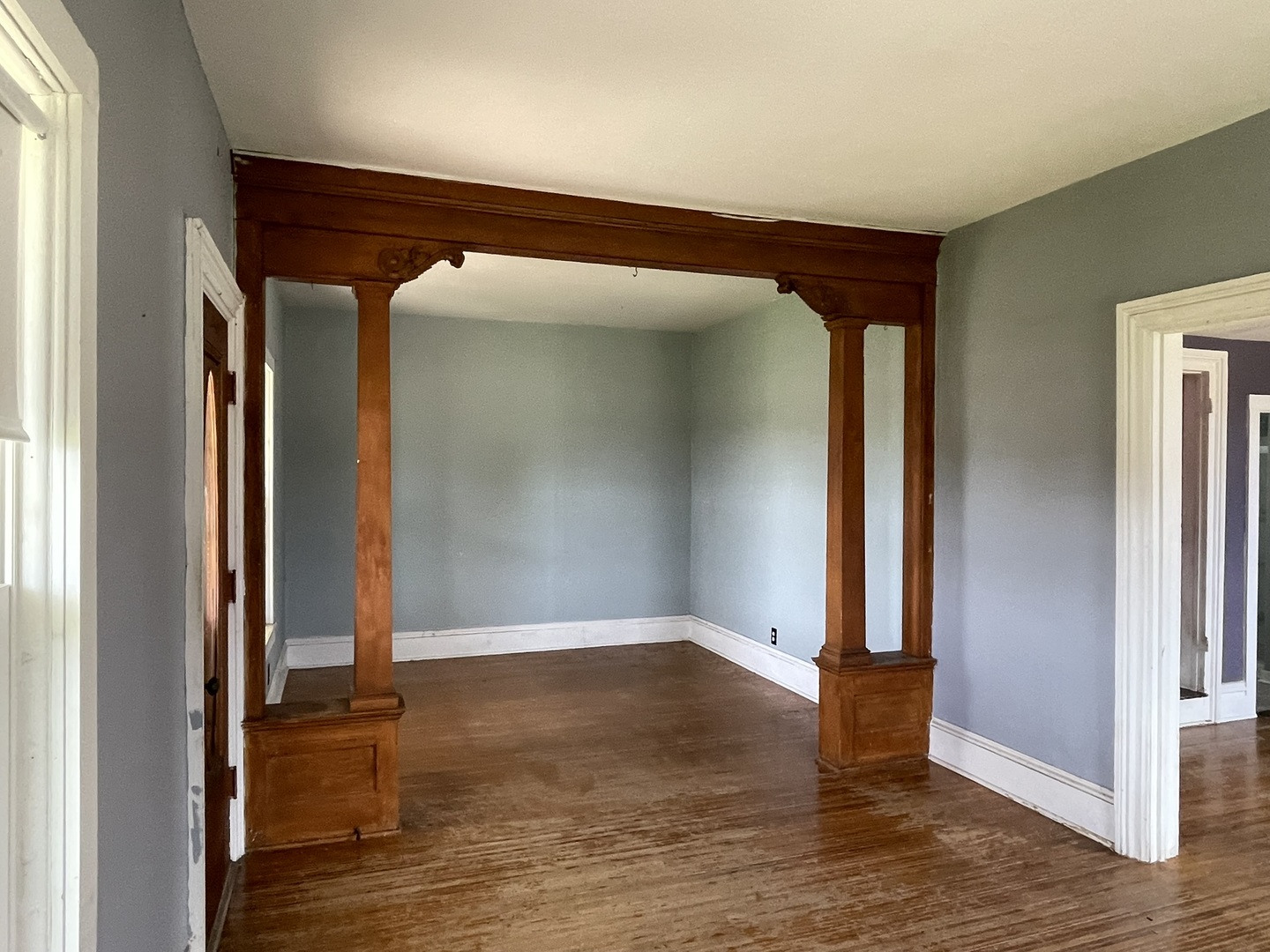 6808 South Oak Grove Road Harvard, IL 60033 - Photo 6 of 18 an empty room with wooden floor and door