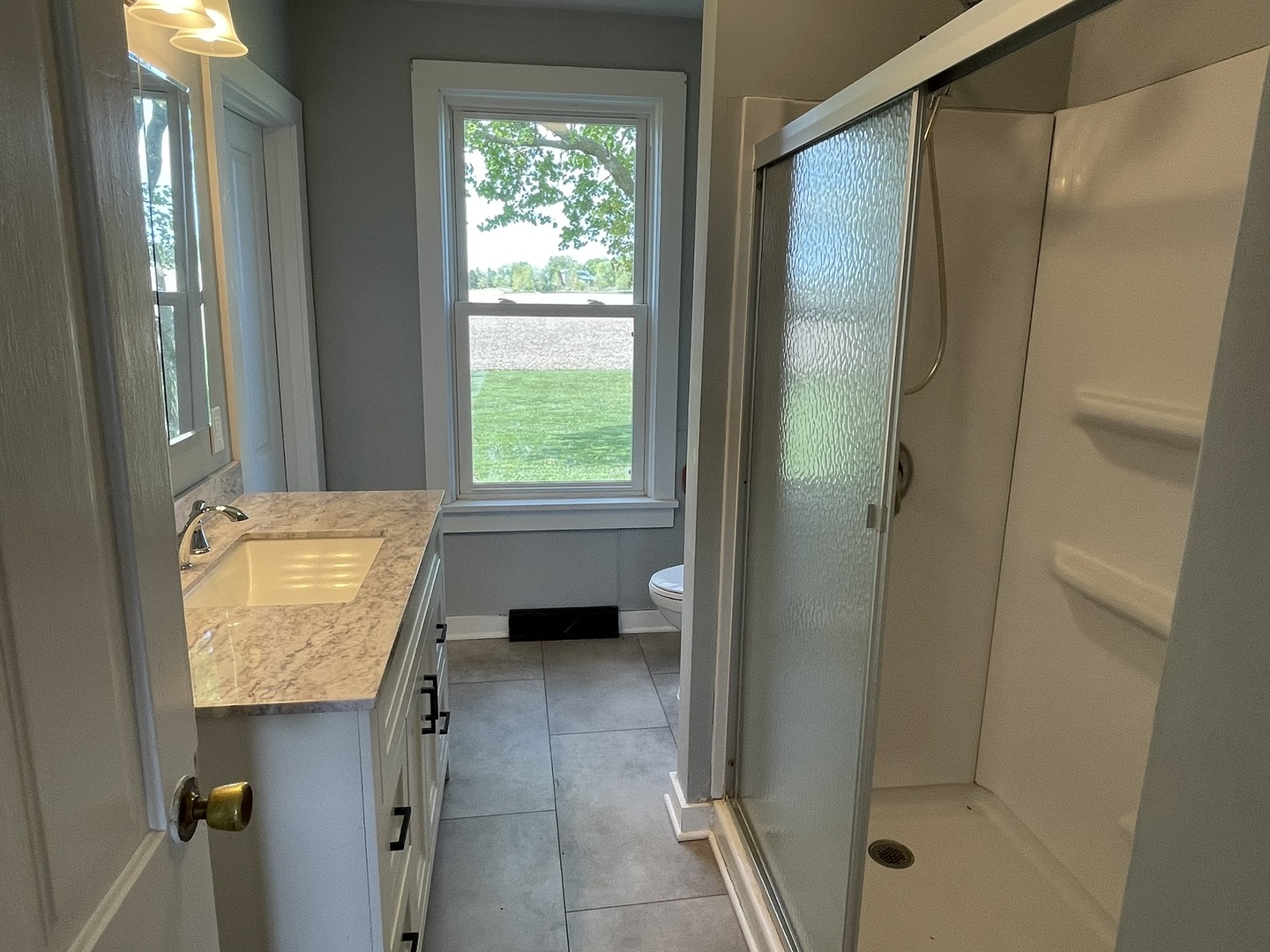 6808 South Oak Grove Road Harvard, IL 60033 - Photo 8 of 18 a bathroom with a tub shower and sink