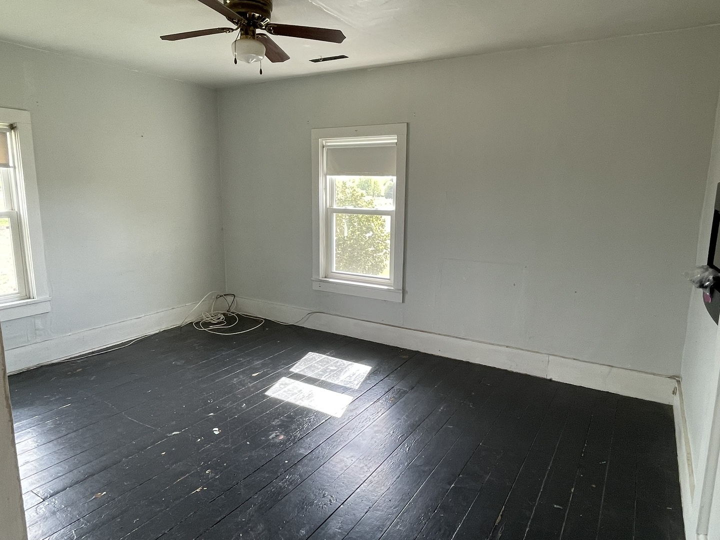 6808 South Oak Grove Road Harvard, IL 60033 - Photo 10 of 18 an empty room with wooden floor and windows