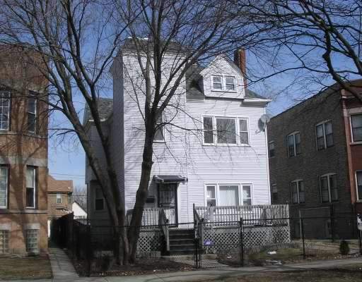 5952 West Rice Street Chicago, IL 60651 - Photo 1 of 1 a front view of a building with large trees