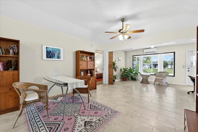 a living room with furniture a rug and a chandelier