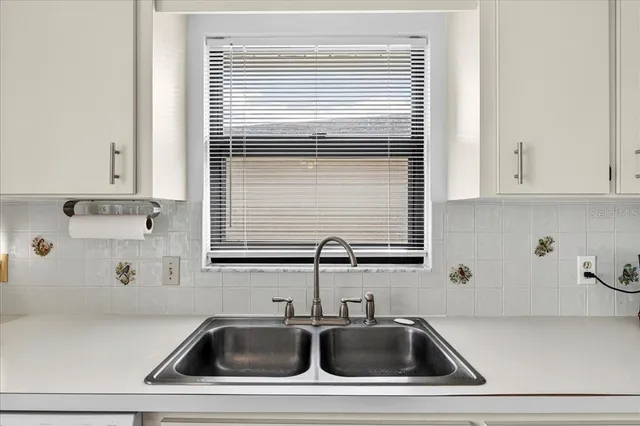a bathroom with a sink and a window