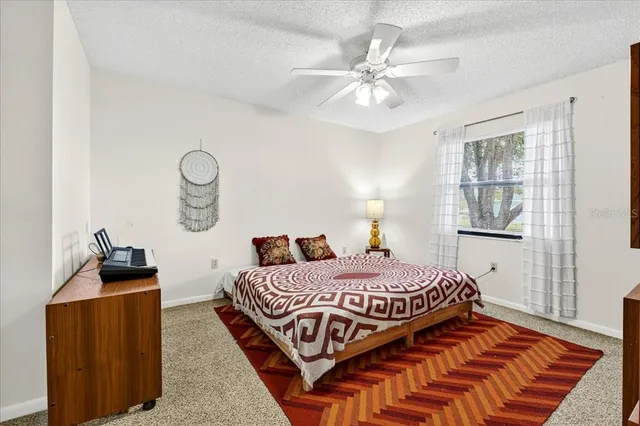 a bedroom with a bed and dresser with mirror