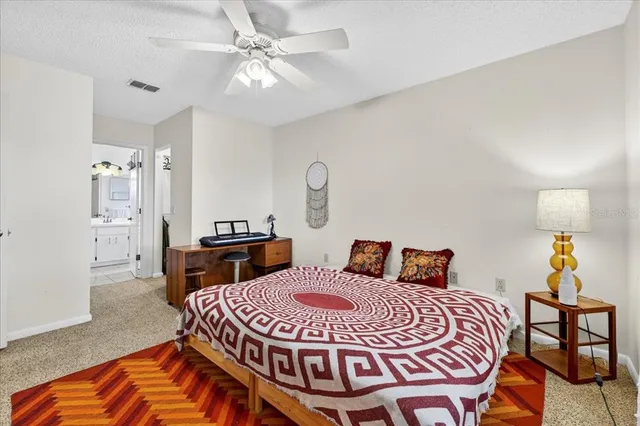 a bedroom with a bed and dresser with mirror