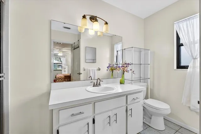 a bathroom with a sink a toilet and mirror