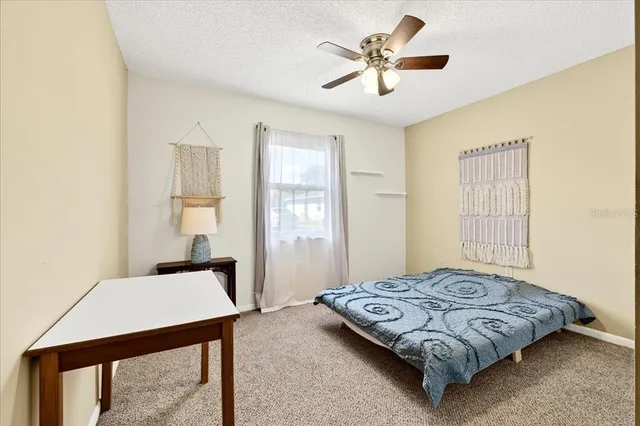 a bedroom with a bed and a table in it