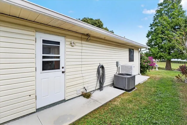 a backyard of a house with barbeque oven and a fire pit