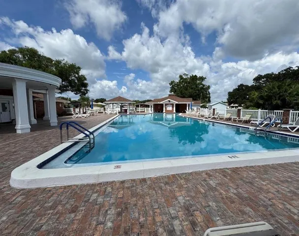a view of patio with table and chairs and a floor to ceiling window