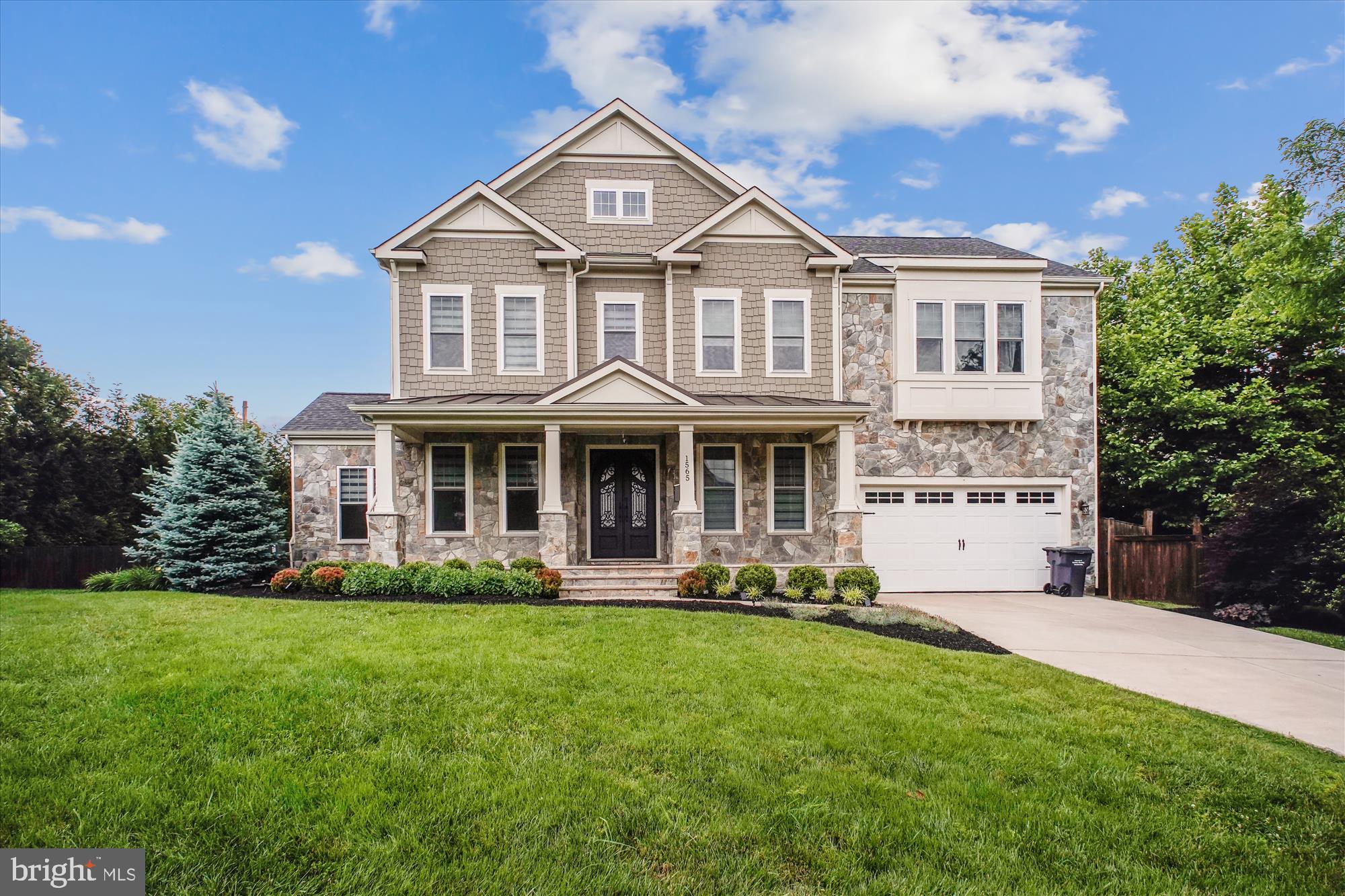 1565 Hane Street McLean, VA 22101 - Photo 1 of 43 a front view of a house with a yard potted plants and a bench