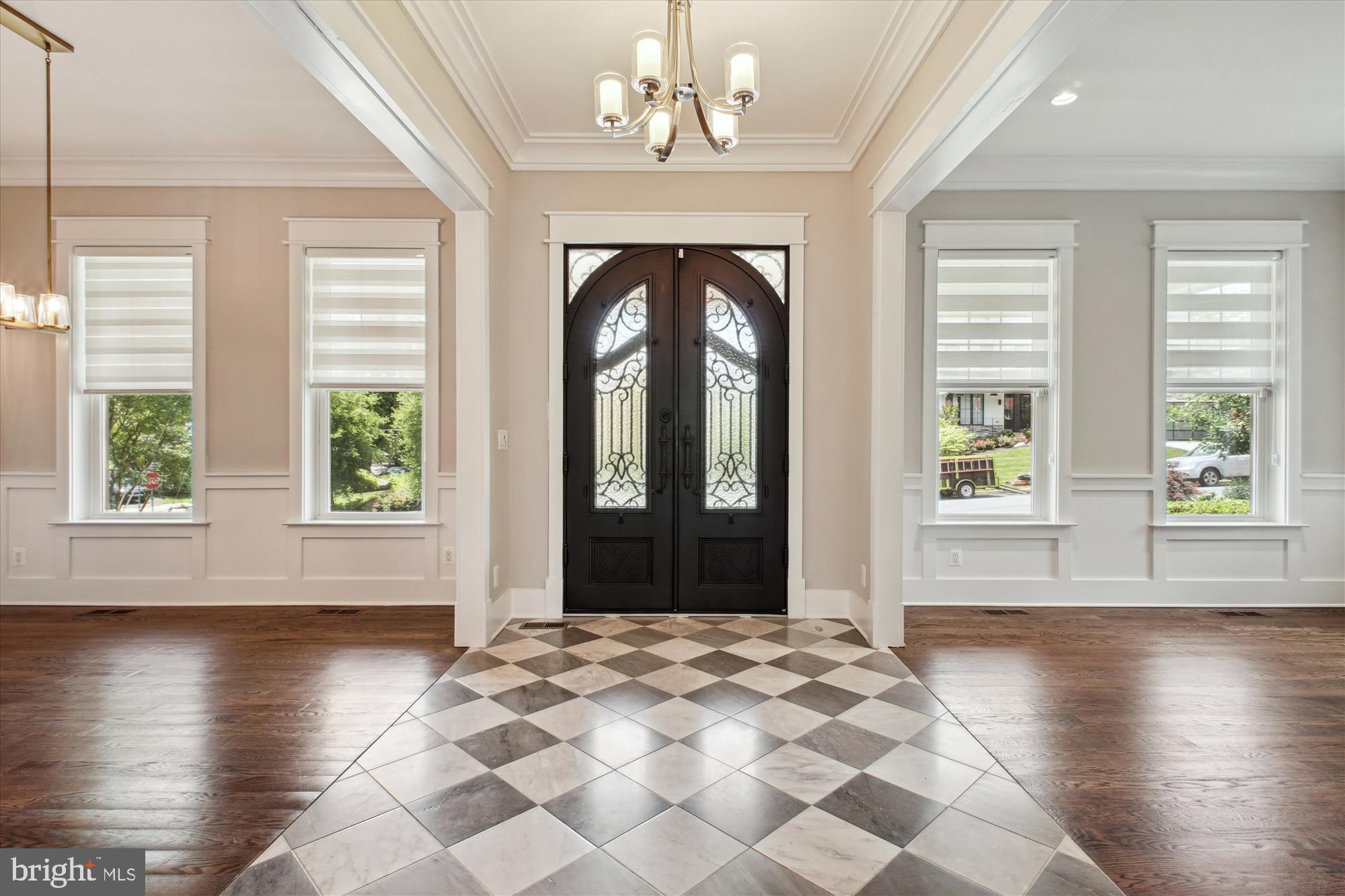 1565 Hane Street McLean, VA 22101 - Photo 2 of 43 an empty room with wooden floor windows and chandelier