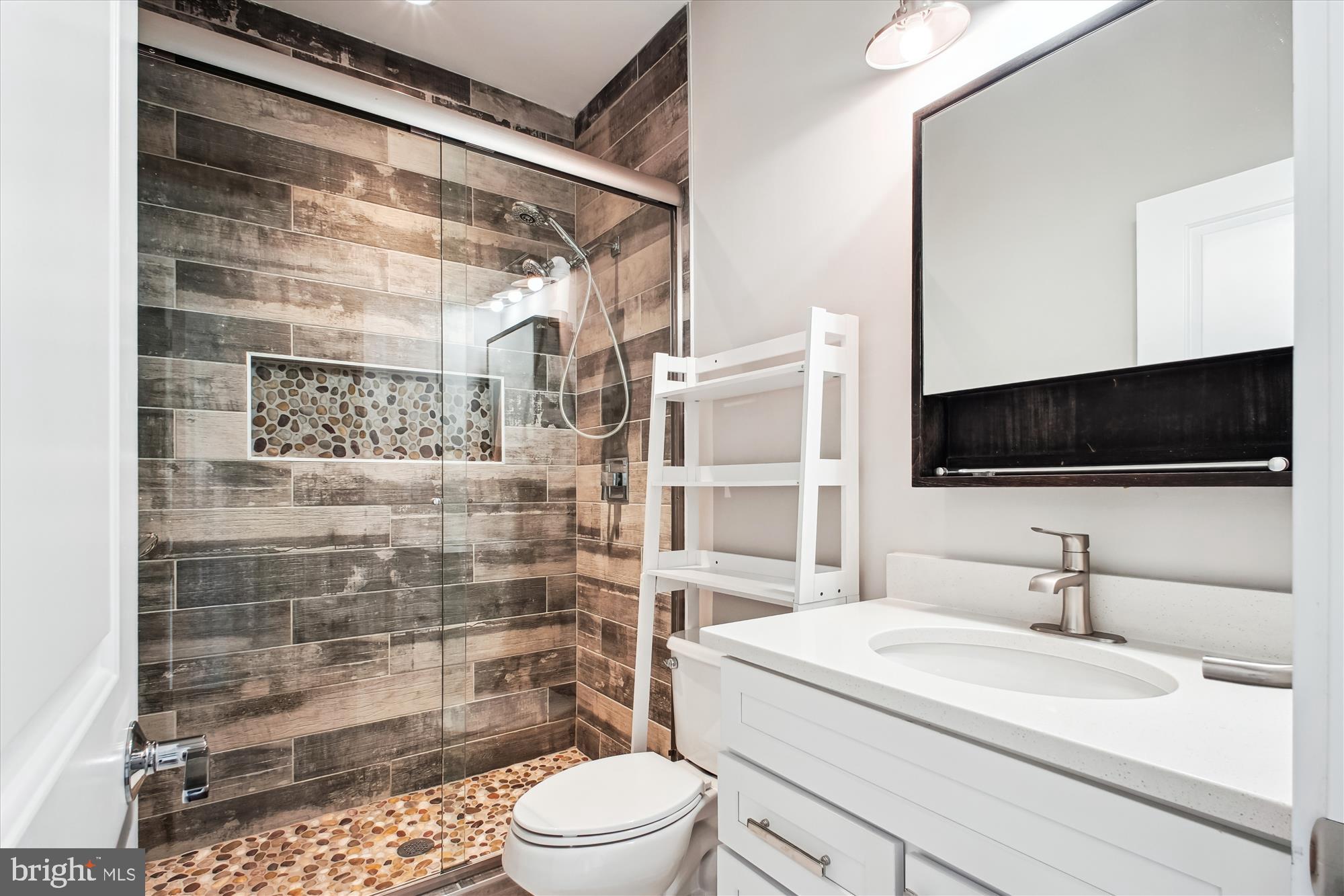 1565 Hane Street McLean, VA 22101 - Photo 24 of 43 a bathroom with a sink a toilet a mirror and shower