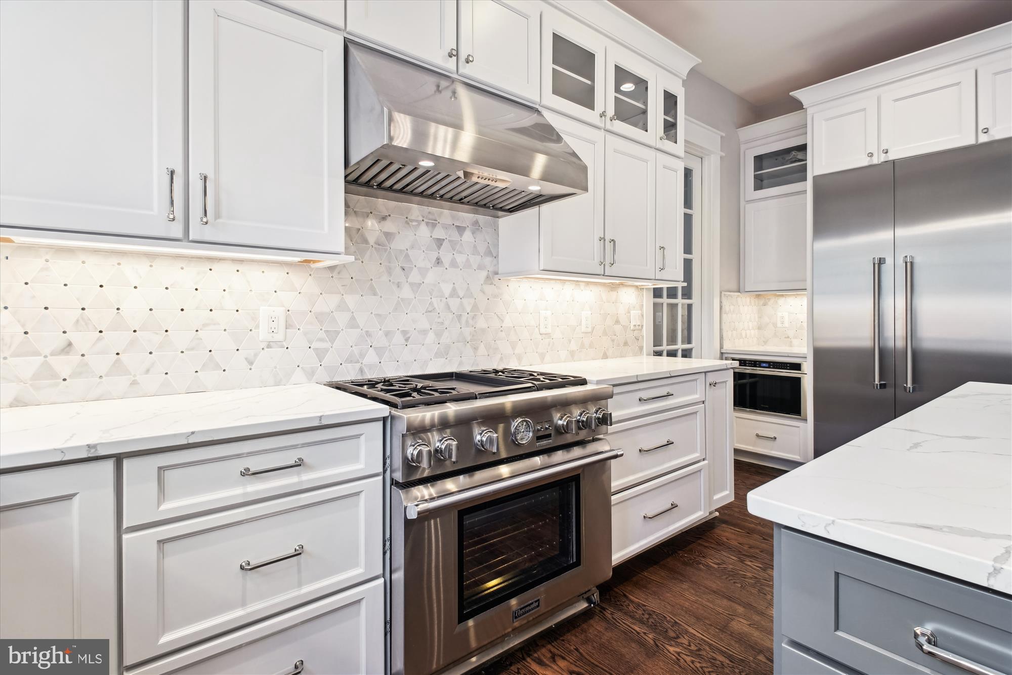 1565 Hane Street McLean, VA 22101 - Photo 35 of 43 a kitchen with cabinets stainless steel appliances and wooden floor