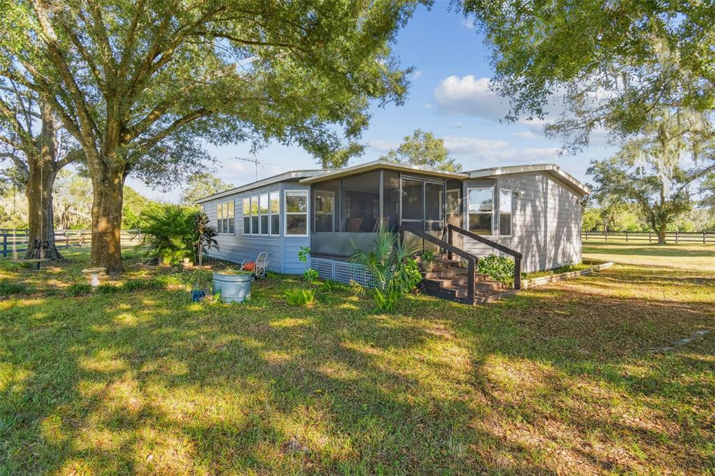12714 Tyler Run Avenue Odessa, FL 33556 - Photo 28 of 65 a view of a house with a big yard and large trees
