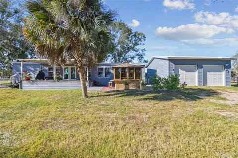 a large kitchen with kitchen island a sink stainless steel appliances and cabinets