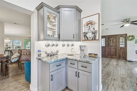 a view of a room with a large window and chairs