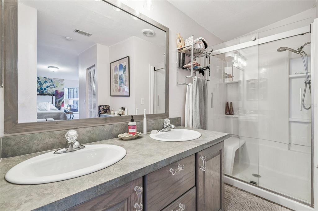 12714 Tyler Run Avenue Odessa, FL 33556 - Photo 34 of 65 a bathroom with a sink double vanity granite tub shower and a mirror