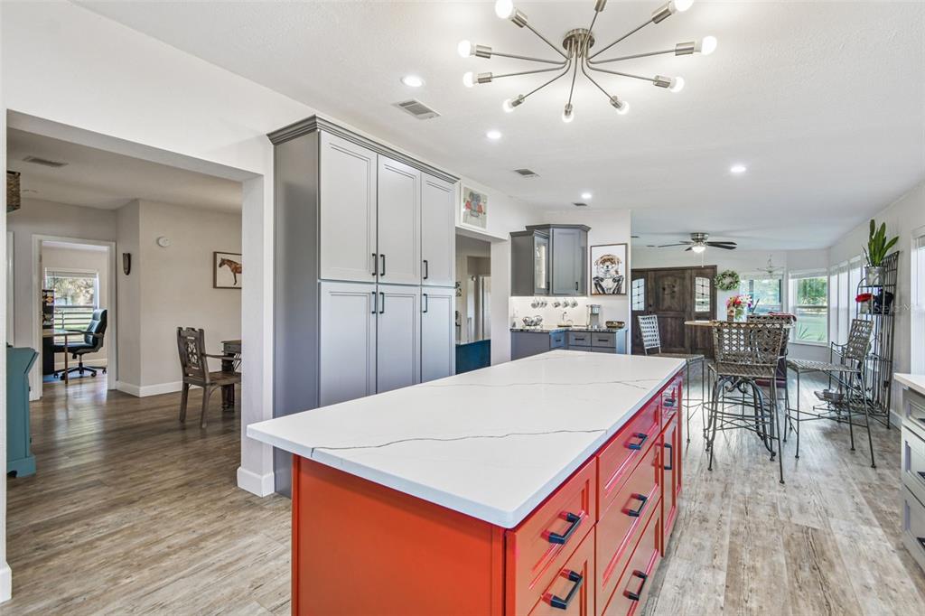 12714 Tyler Run Avenue Odessa, FL 33556 - Photo 35 of 65 a room with stainless steel appliances kitchen island granite countertop a table chairs and a refrigerator