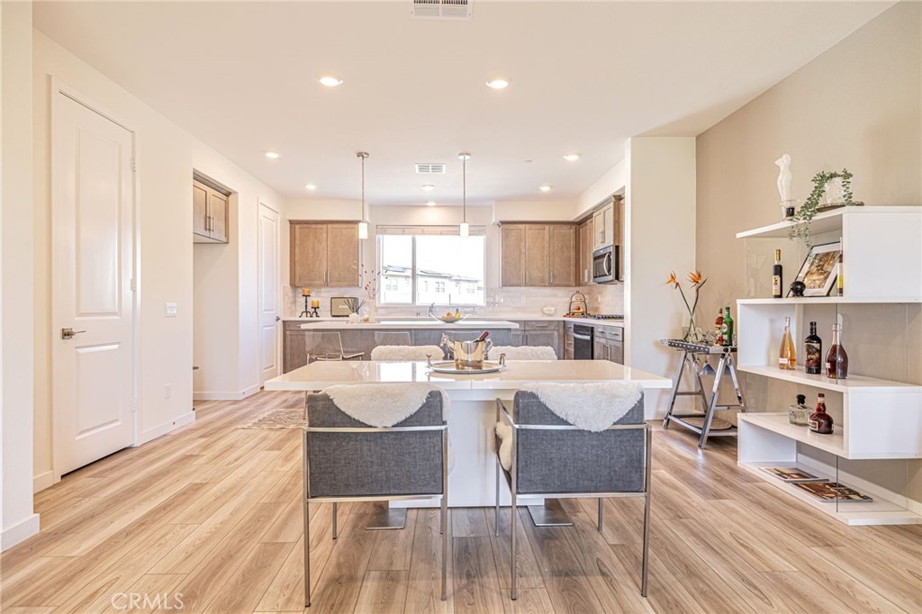 27555 Sanctuary Court Stevenson Ranch, CA 91381 - Photo 15 of 29 a large kitchen with a table and chairs