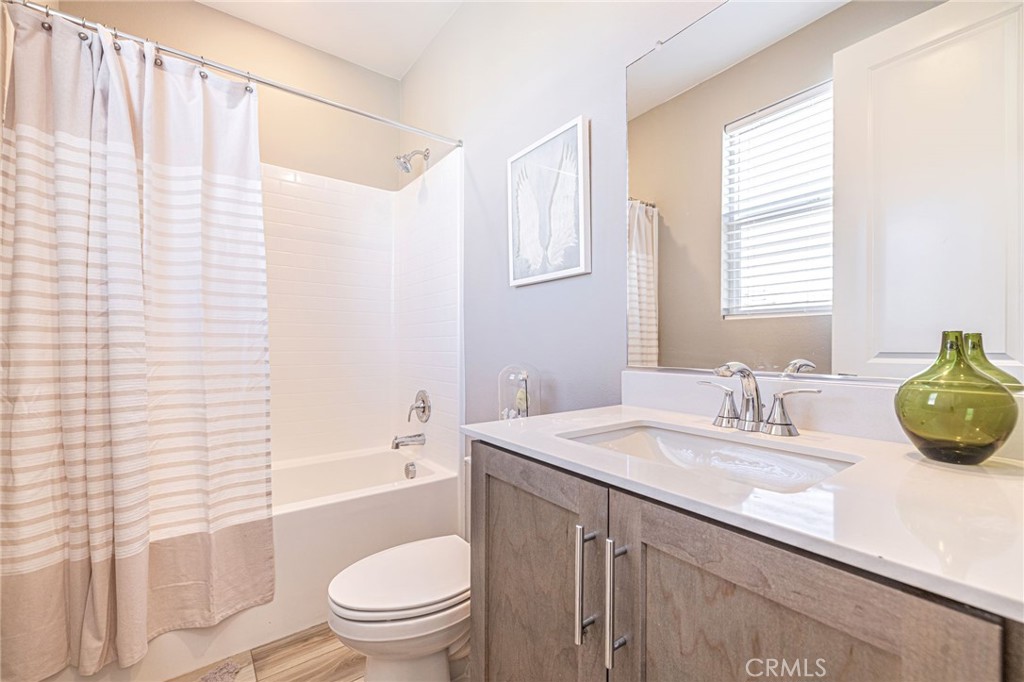 27555 Sanctuary Court Stevenson Ranch, CA 91381 - Photo 22 of 29 a bathroom with a granite countertop sink toilet and shower