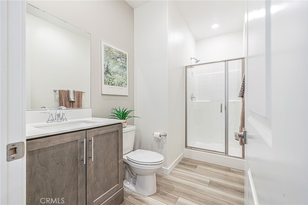 27555 Sanctuary Court Stevenson Ranch, CA 91381 - Photo 26 of 29 a bathroom with a toilet a sink and mirror
