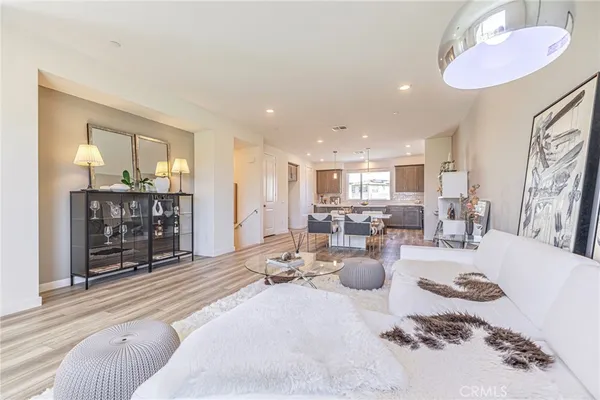 a living room with lots of furniture and view of kitchen