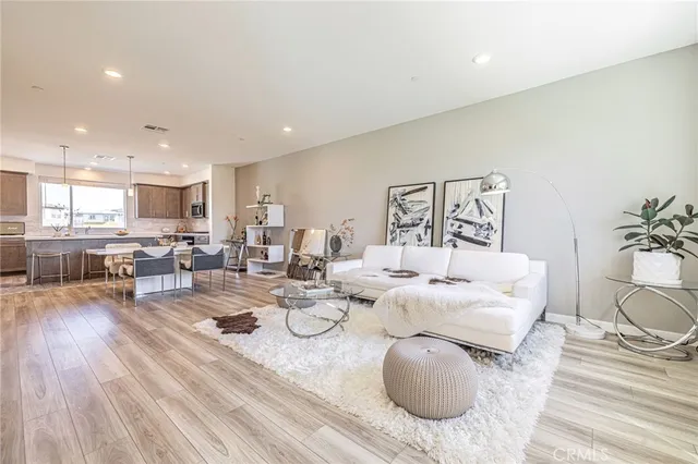 a large white kitchen with a large window and counter space