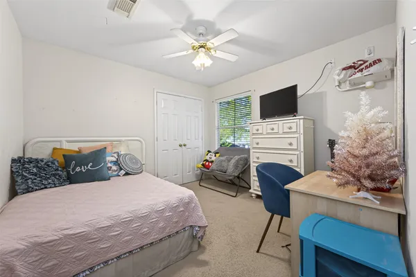 a bedroom with a bed and a flat screen tv