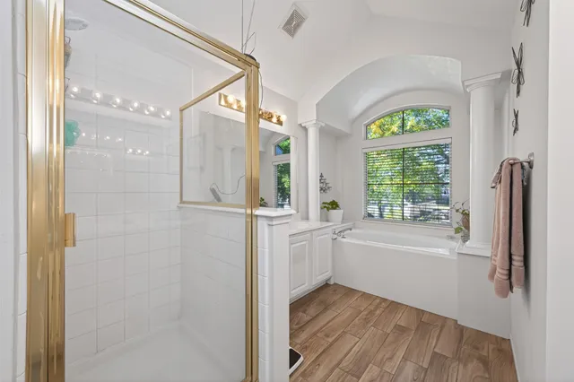 a bathroom with a bathtub a sink and a shower