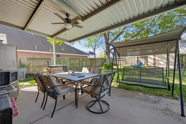 a view of outdoor sitting area with furniture and backyard