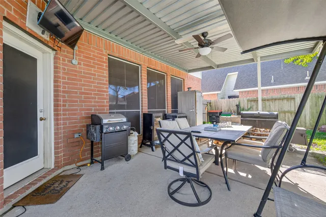 a view of a patio with a table and chairs